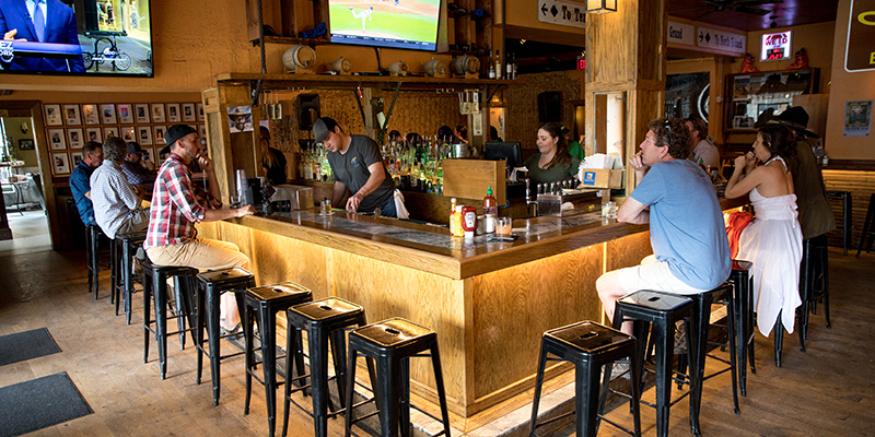 People sitting at the historic Murray Bar, Livingston, Montana.