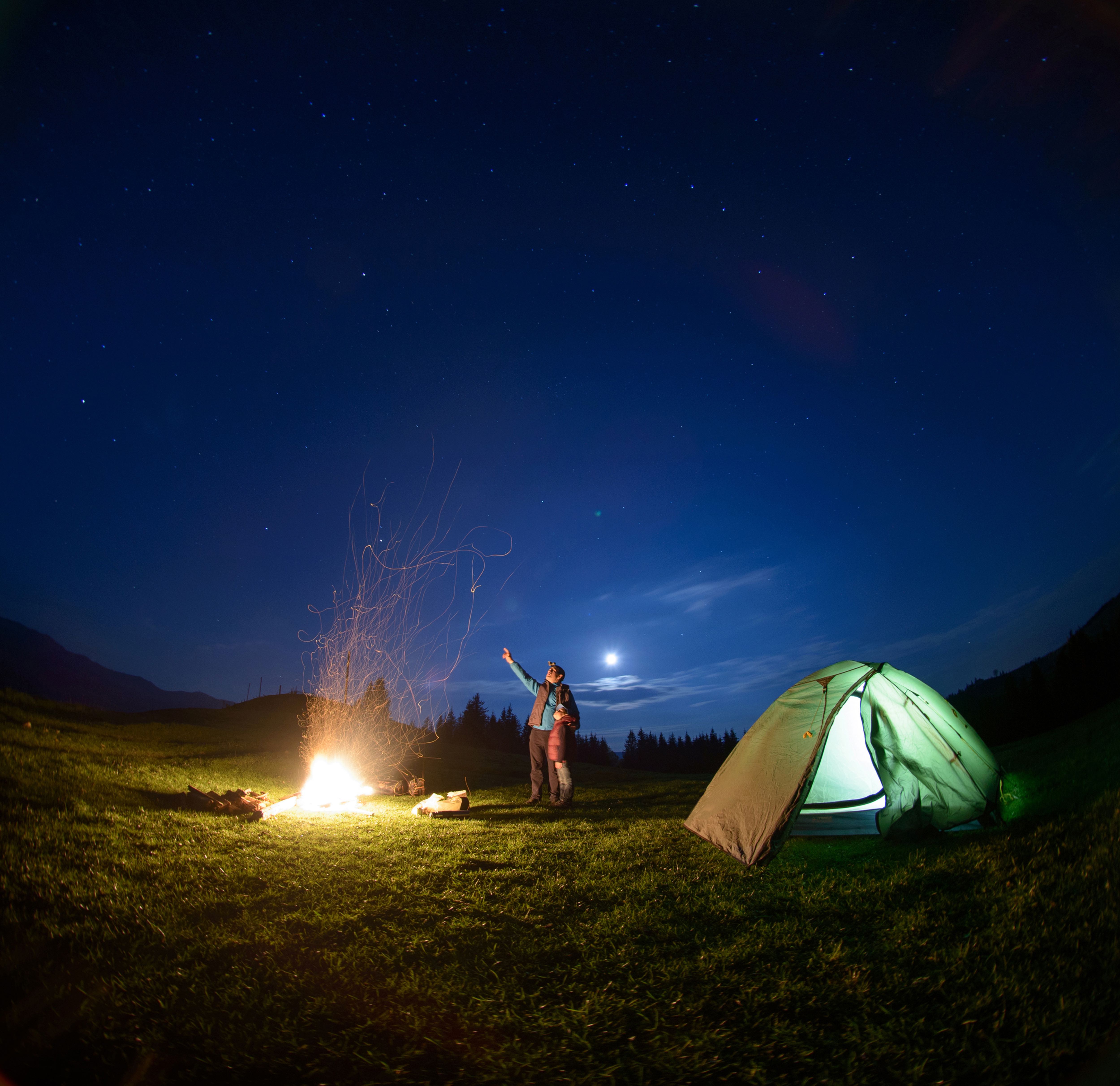 Camping at night around the fire in Yellowstone Country Montana