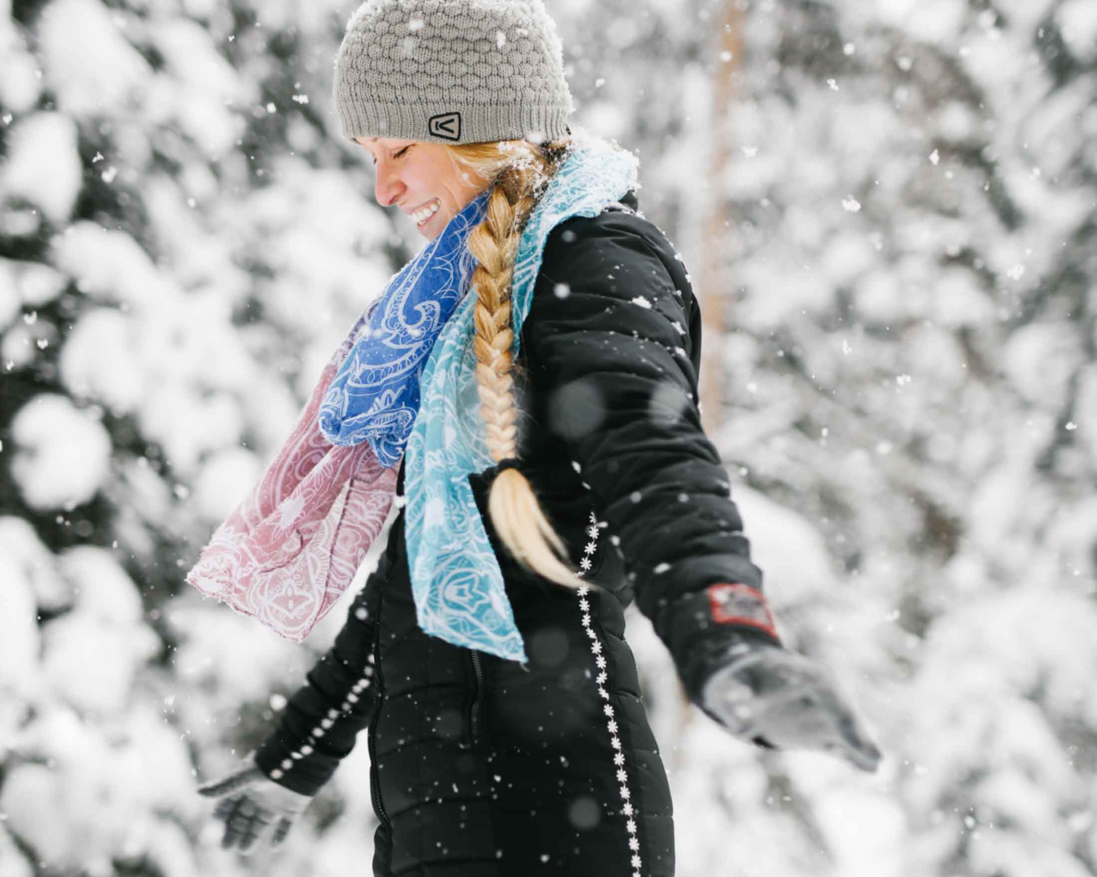 Woman enjoys the falling snow in Yellowstone Country Montana