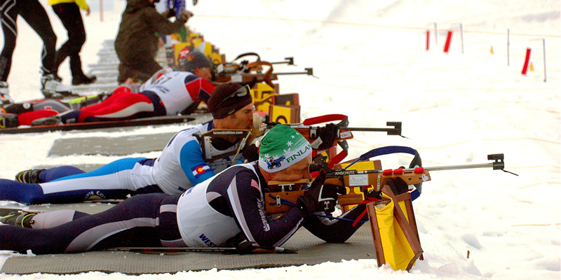 Competitors on a biathlon range. 