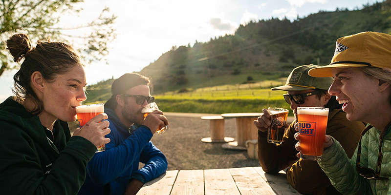Friends enjoying beer Boulder River Road Kill, McLeod, Montana