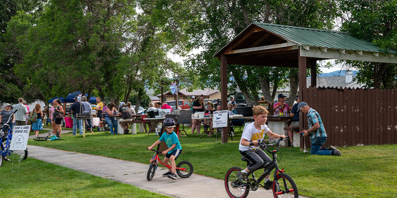 Kids riding bikes at Shileds Valley Farmers Market, Montana